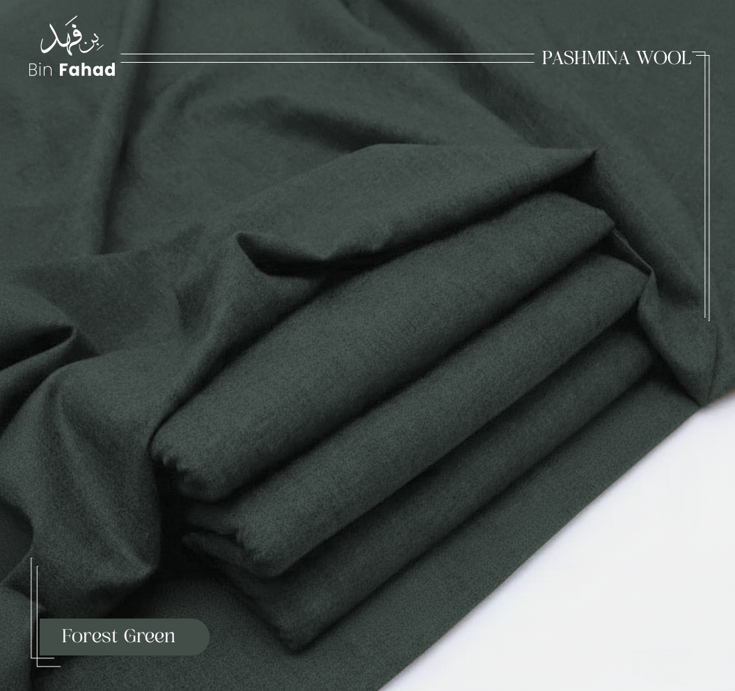 Folded forest green pashmina wool fabric on a white background