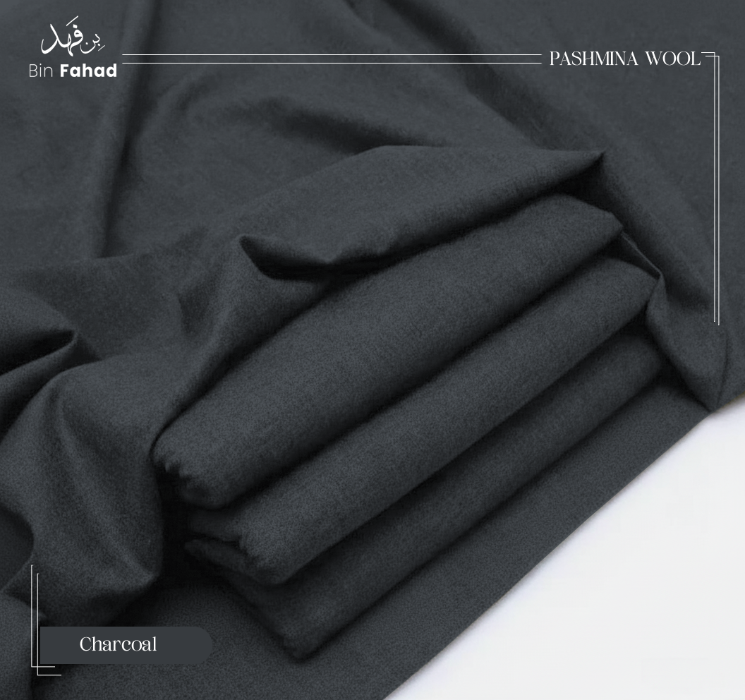 Folded charcoal gray pashmina wool fabric on a white background