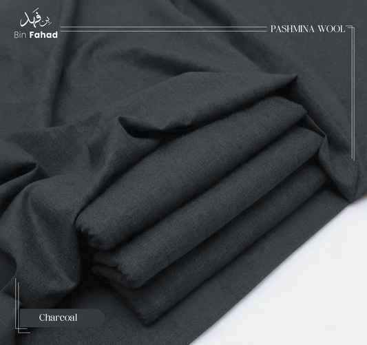 Folded charcoal gray pashmina wool fabric on a white background